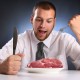 young man eating raw meat